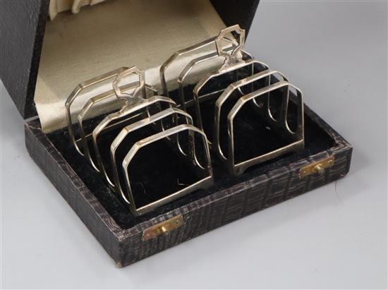 A cased pair of 1930s silver five bar toastracks by Henry Clifford Davis, length 7cm.